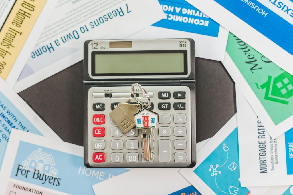 Calculator and house keys on real estate documents