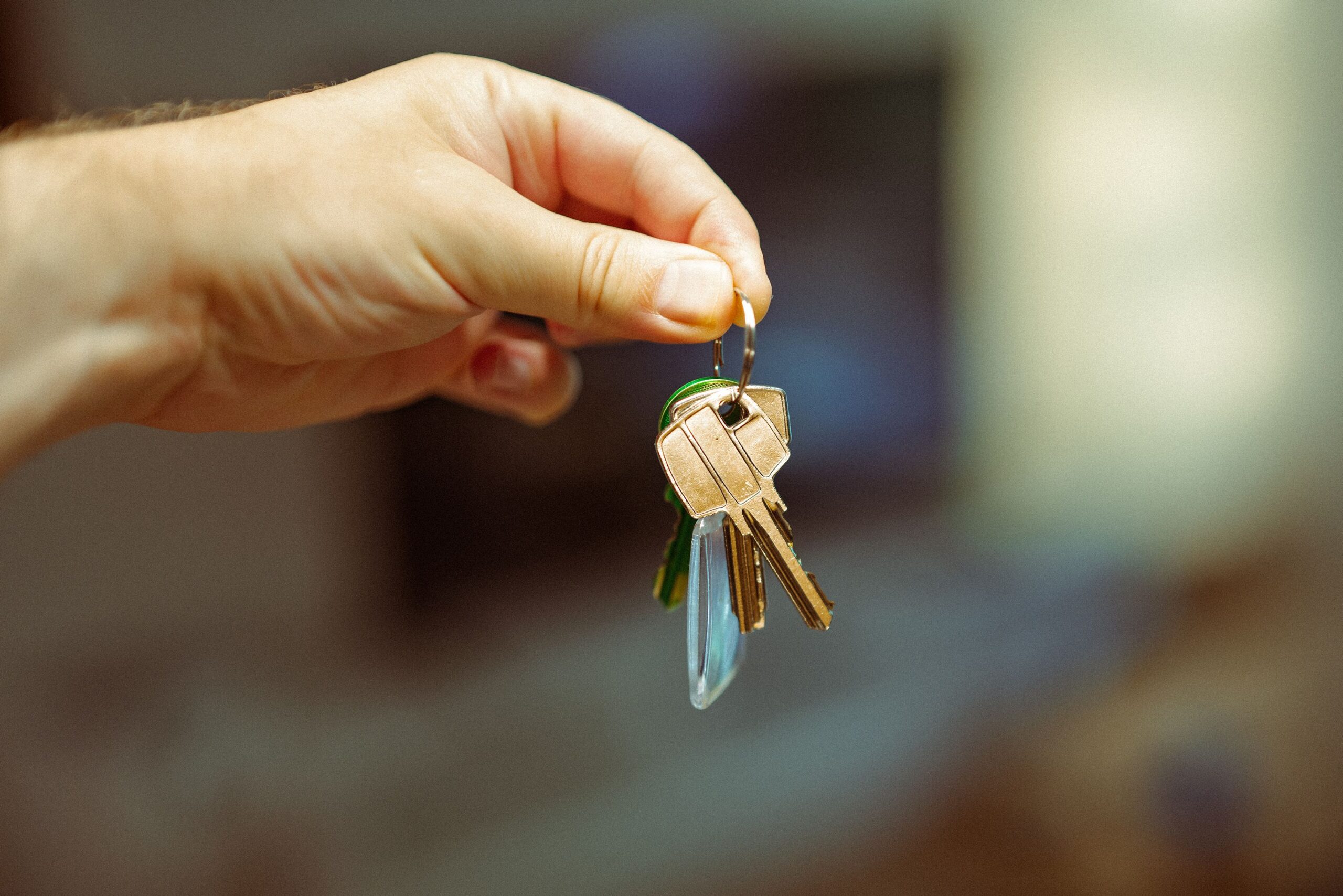 Hand holding house keys for a home